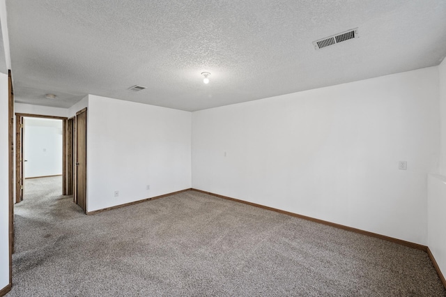 spare room with visible vents, baseboards, and carpet