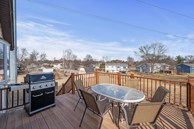 wooden deck featuring a residential view, area for grilling, and outdoor dining space