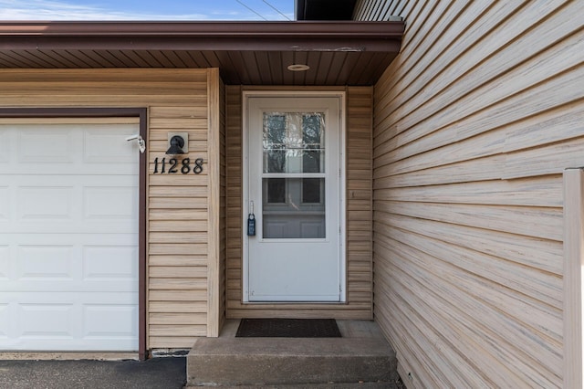 doorway to property with a garage