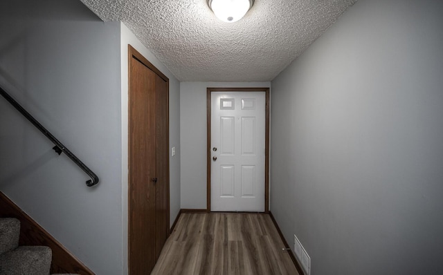 entryway featuring hardwood / wood-style floors and a textured ceiling