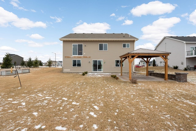 rear view of property with a gazebo and a patio