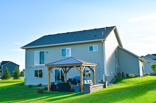 back of house featuring a gazebo, a yard, an outdoor living space, and central air condition unit