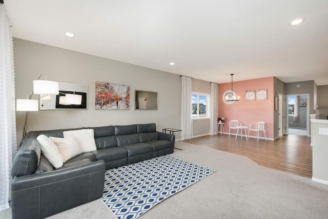 living room featuring an inviting chandelier and hardwood / wood-style floors