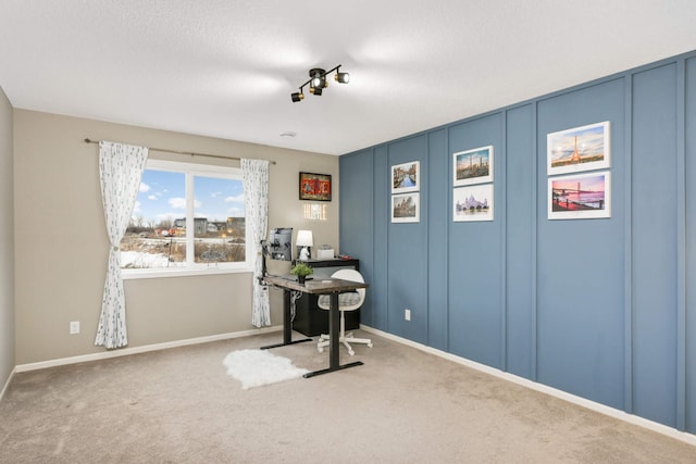 carpeted office space featuring a textured ceiling