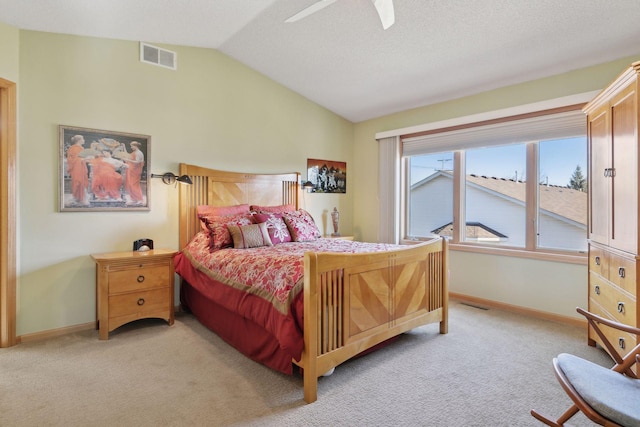 bedroom with vaulted ceiling, light colored carpet, a textured ceiling, and ceiling fan