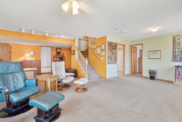 sitting room with light colored carpet and a textured ceiling