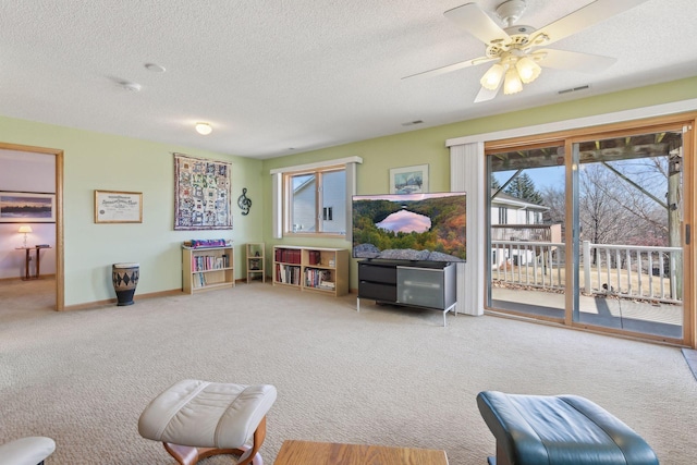 playroom with ceiling fan, carpet floors, and a textured ceiling