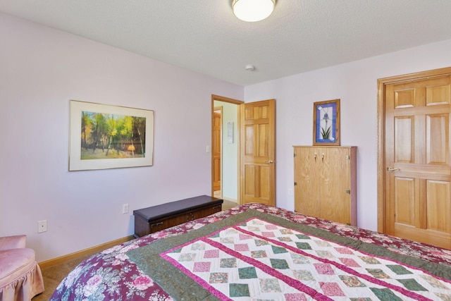 bedroom featuring a textured ceiling and carpet