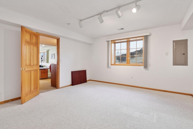 unfurnished room featuring light colored carpet and electric panel