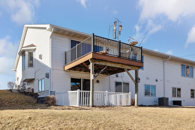 rear view of property with cooling unit, a yard, and a deck