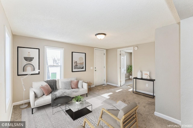 living room featuring light carpet and a textured ceiling