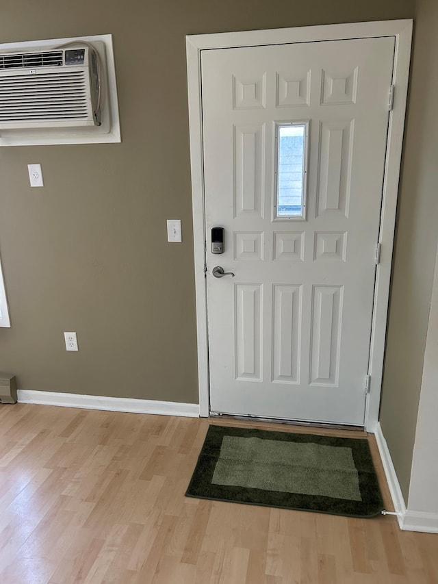 entrance foyer with a wall mounted AC and light hardwood / wood-style flooring