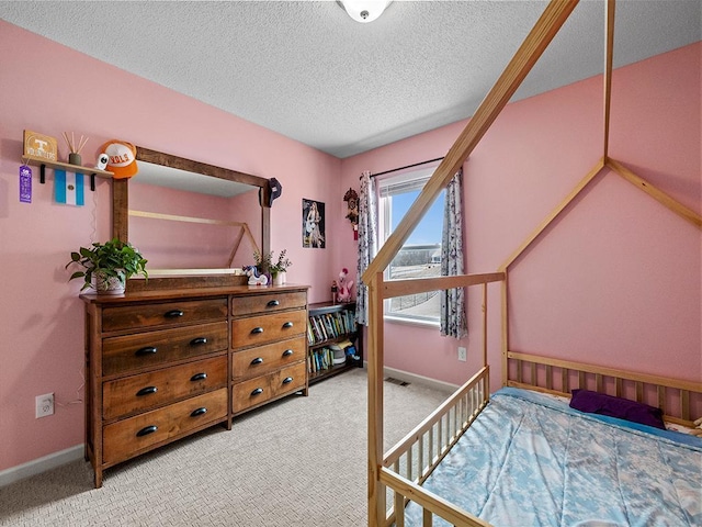 carpeted bedroom featuring a textured ceiling