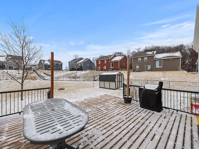 wooden deck with a storage shed