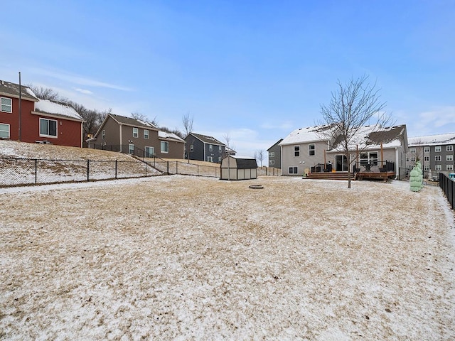 view of yard featuring a deck and a shed