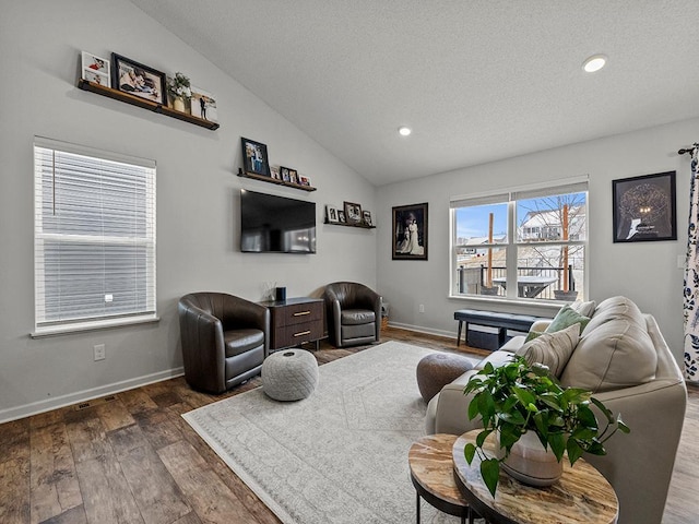 living room with lofted ceiling, recessed lighting, a textured ceiling, wood finished floors, and baseboards