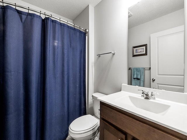 full bath with toilet, a textured ceiling, and vanity