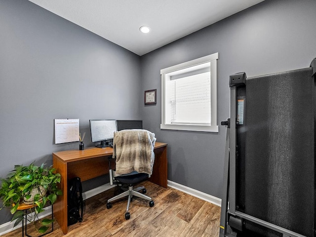 home office featuring baseboards and wood finished floors