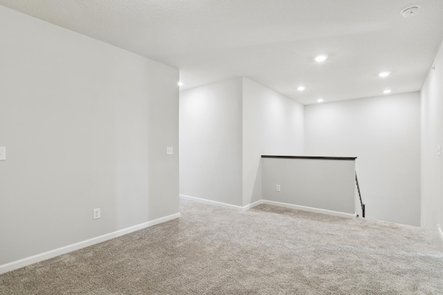 spare room featuring light colored carpet