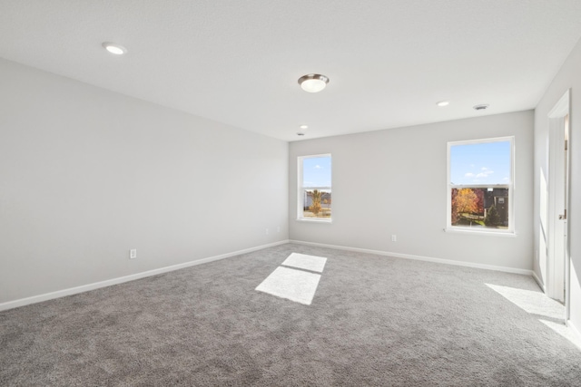 spare room with a healthy amount of sunlight and light colored carpet