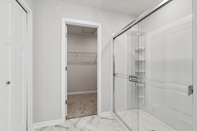 bathroom featuring a shower with door