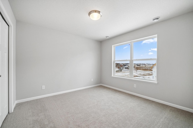 unfurnished bedroom with carpet floors, a closet, and baseboards