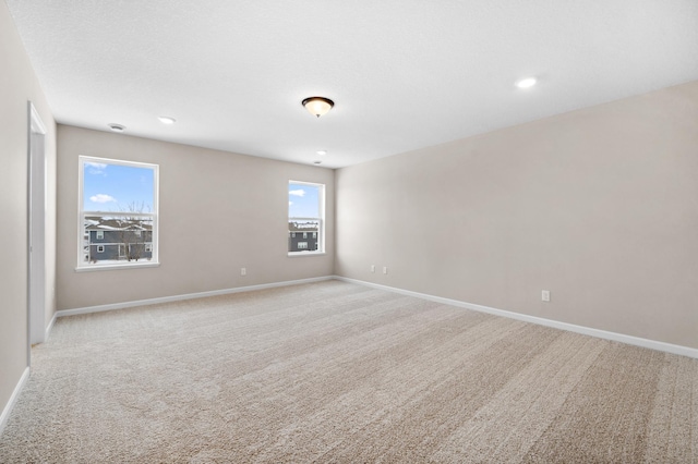 spare room featuring light colored carpet