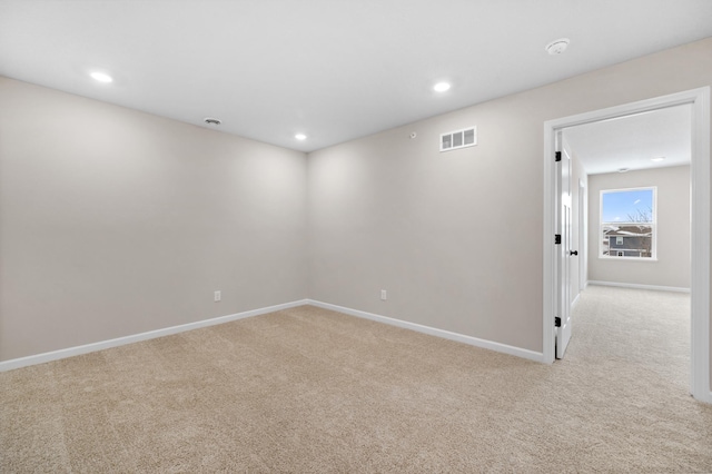 spare room featuring carpet floors, recessed lighting, visible vents, and baseboards