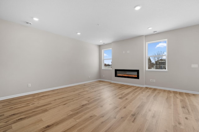 unfurnished living room featuring light wood-type flooring