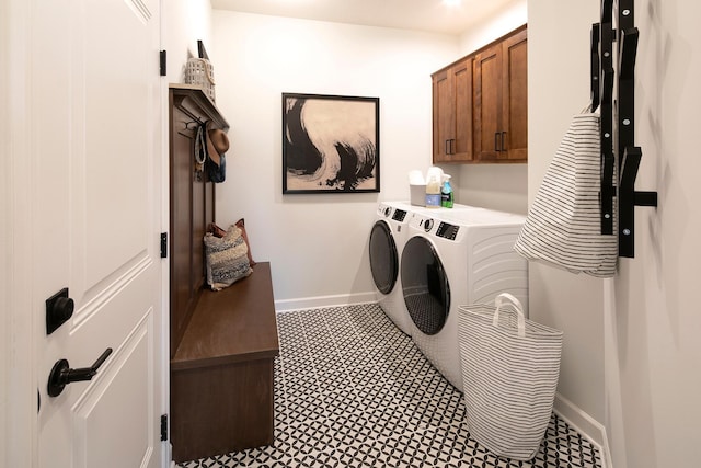 laundry room with baseboards, cabinet space, and washing machine and clothes dryer