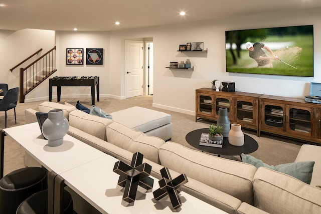 carpeted living area with recessed lighting, stairway, and baseboards