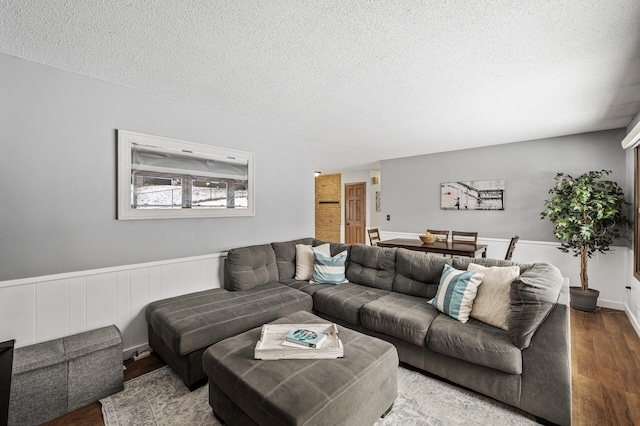 living room featuring hardwood / wood-style floors and a textured ceiling