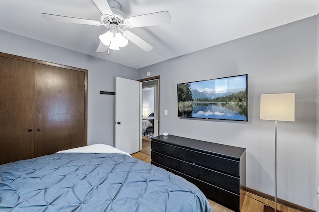 bedroom with light hardwood / wood-style flooring, a closet, and ceiling fan