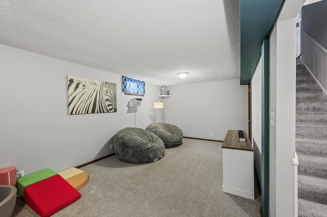 playroom with a textured ceiling and carpet flooring