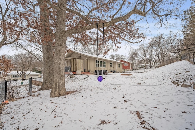 view of snow covered back of property