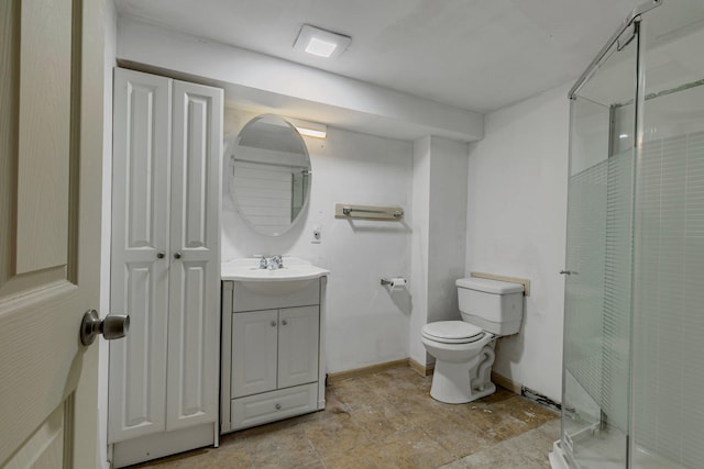 bathroom featuring vanity, toilet, and a shower with shower door