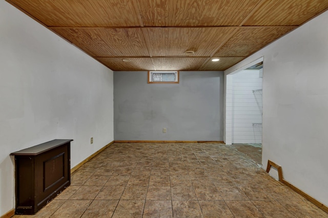 basement featuring light tile patterned floors and wooden ceiling