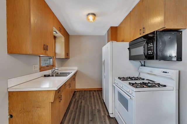 kitchen featuring sink, dark hardwood / wood-style floors, and gas range gas stove