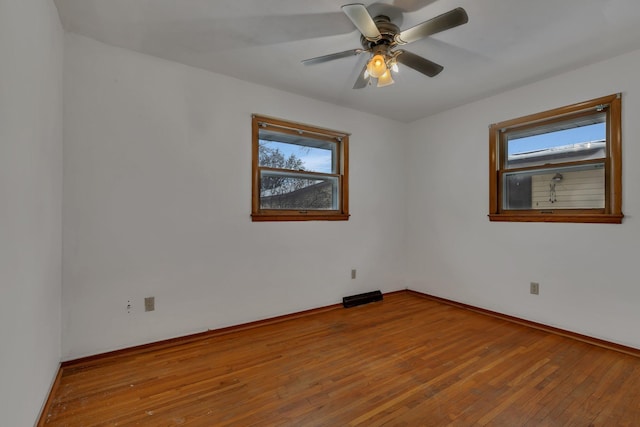 unfurnished room featuring hardwood / wood-style floors and ceiling fan