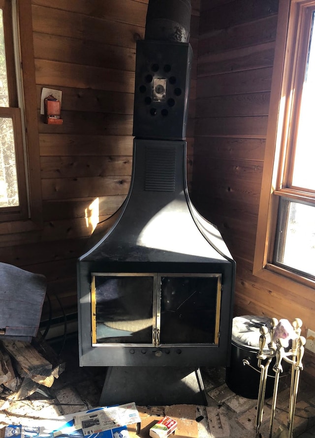 room details featuring wood walls and a wood stove