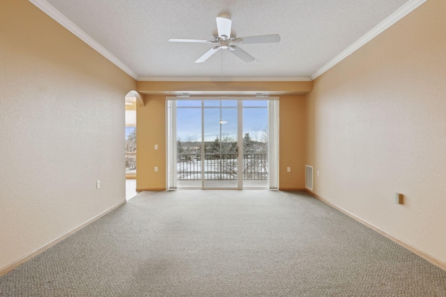 unfurnished room with ceiling fan, ornamental molding, light carpet, and a textured ceiling