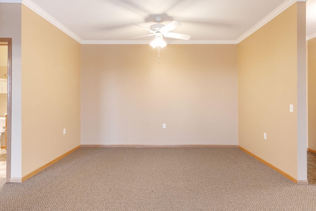 carpeted spare room with ceiling fan and ornamental molding