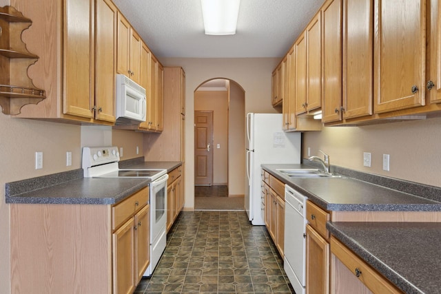 kitchen featuring sink, white appliances, and a textured ceiling