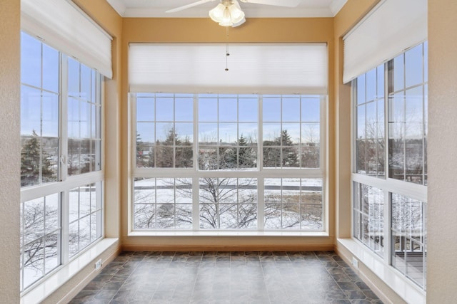 unfurnished sunroom featuring plenty of natural light and ceiling fan