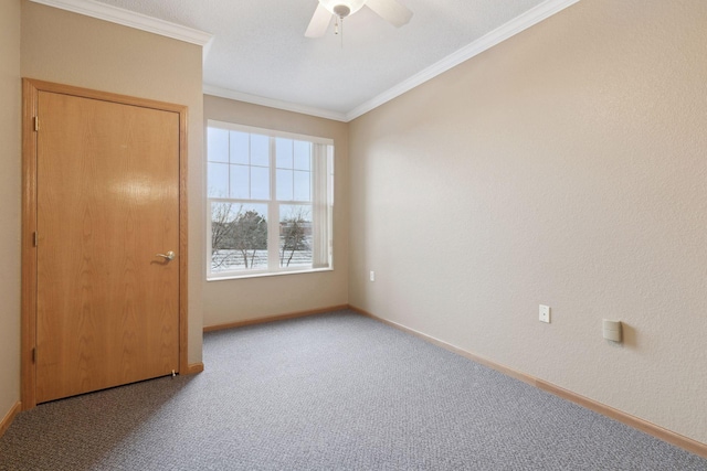 carpeted empty room with ornamental molding and ceiling fan