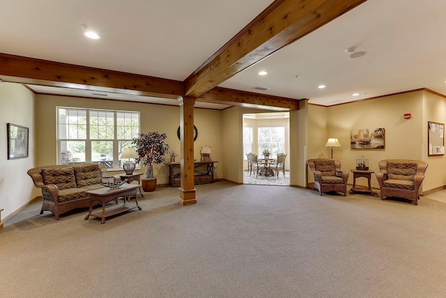 interior space with beamed ceiling, crown molding, carpet floors, and decorative columns