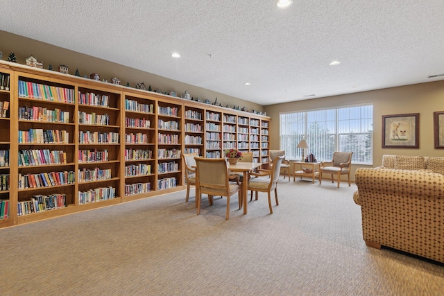 dining area featuring carpet and a textured ceiling