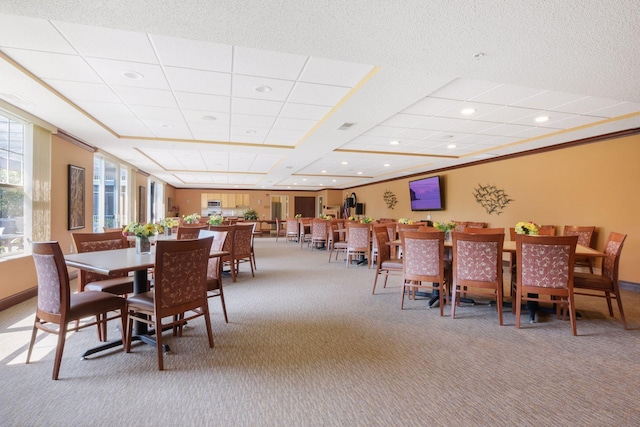 carpeted dining space featuring ornamental molding