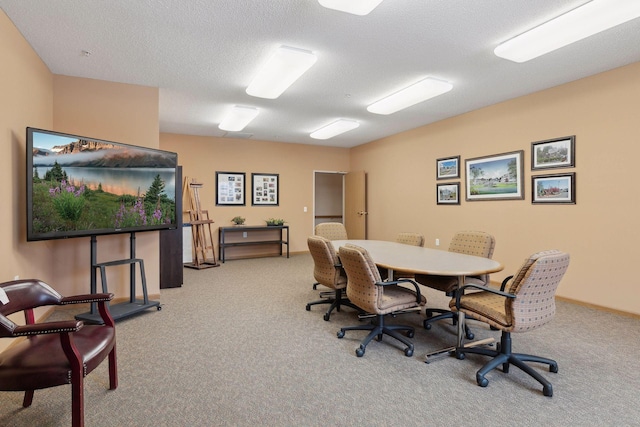 carpeted office space featuring a textured ceiling