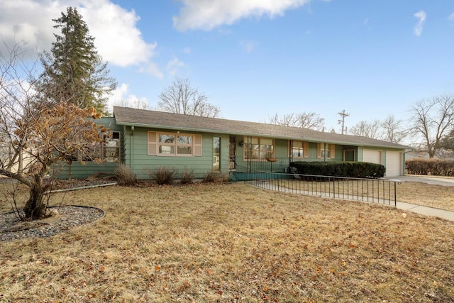 single story home featuring a garage and a front lawn